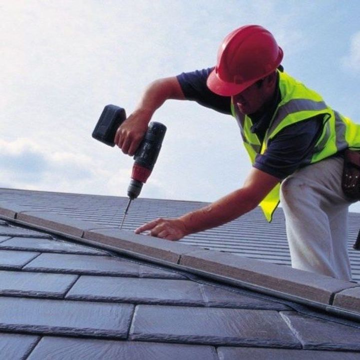 man setting the roof tiles